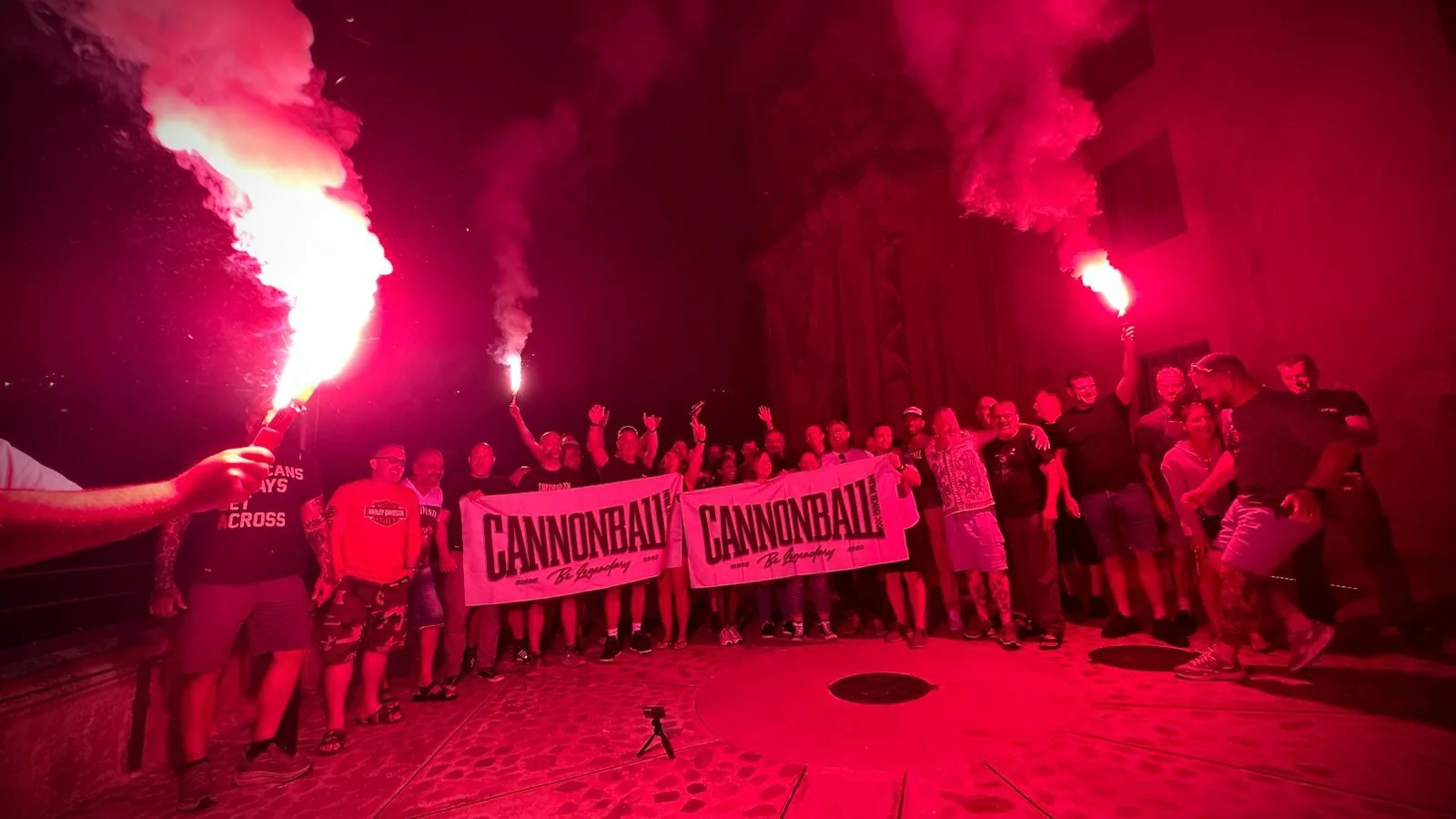 Cannonball Bike Run 2026 riders with flares at the pre-finish party in Spain