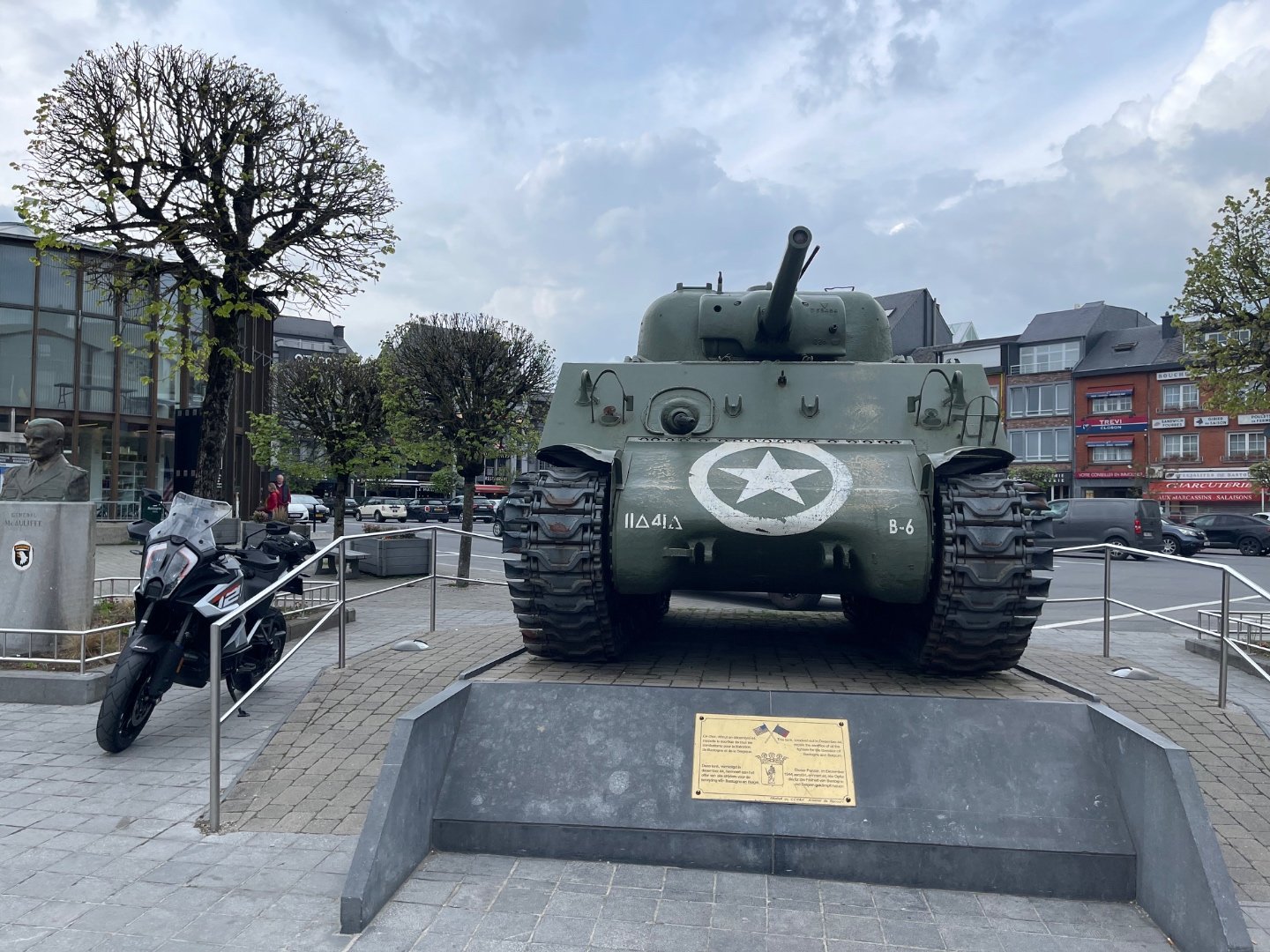 Front view of the Sherman tank Barracuda on McAuliffe Square in Bastogne with the McAuliffe bust to the left