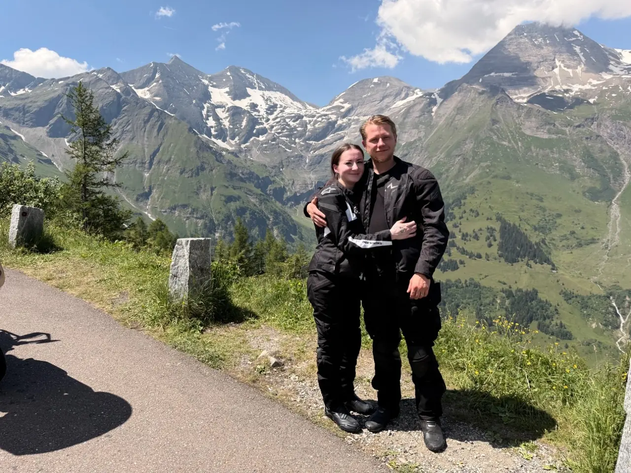 Riders taking a break at a roadside viewpoint on the Grossglockner Hochalpenstrasse